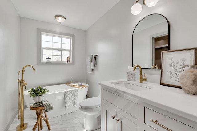 bathroom featuring a bathing tub, vanity, and toilet