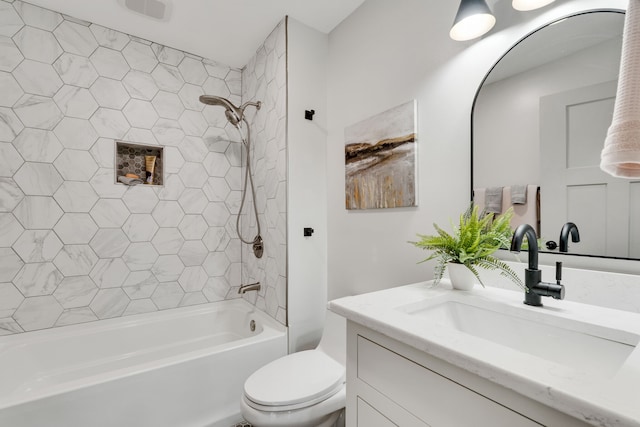 full bathroom with tiled shower / bath, vanity, and toilet