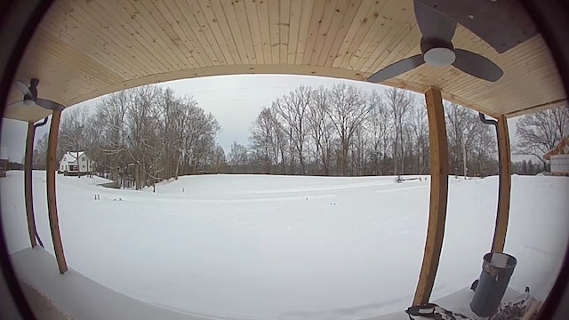 yard layered in snow featuring ceiling fan