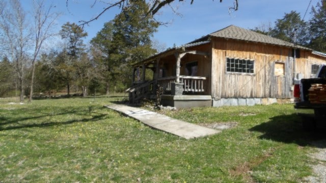 view of side of property featuring a yard