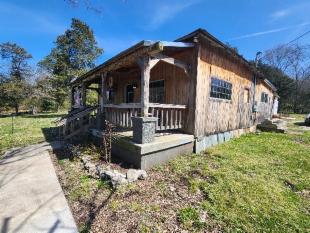 exterior space featuring a porch and a front lawn