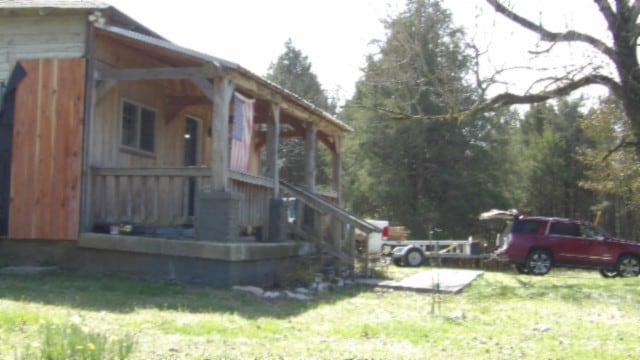 view of side of home featuring a lawn