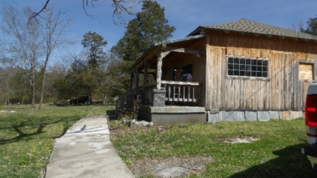 view of side of home featuring a lawn