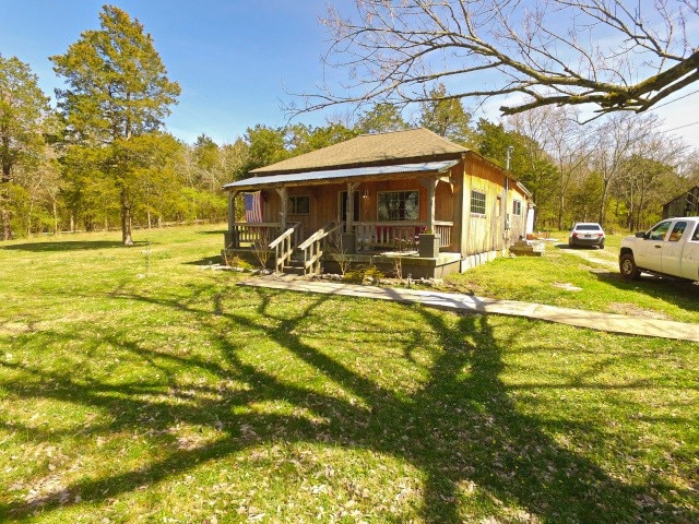 view of yard with covered porch