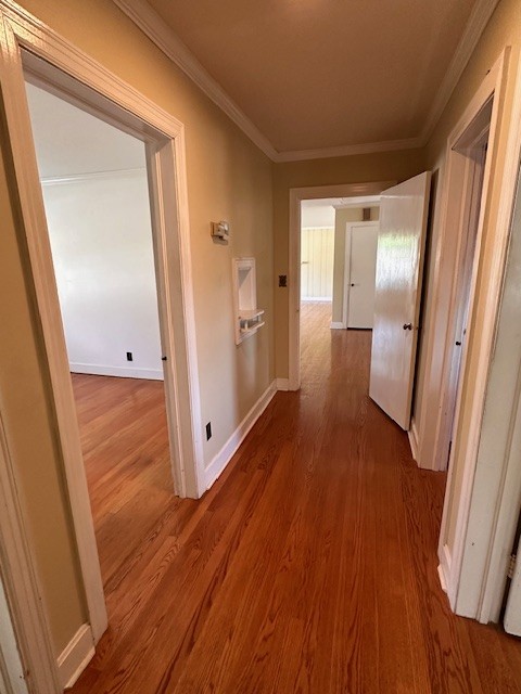 corridor featuring crown molding and hardwood / wood-style floors