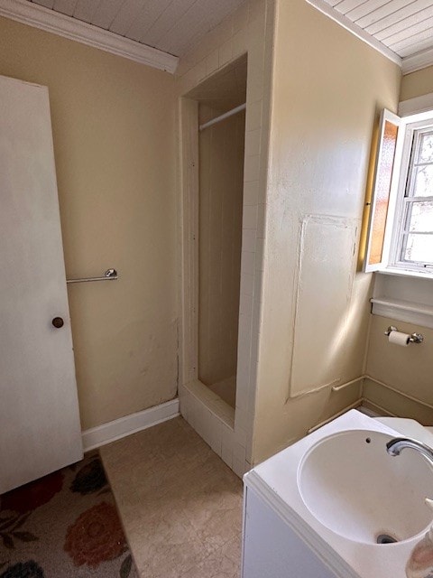 bathroom featuring walk in shower, sink, and tile flooring