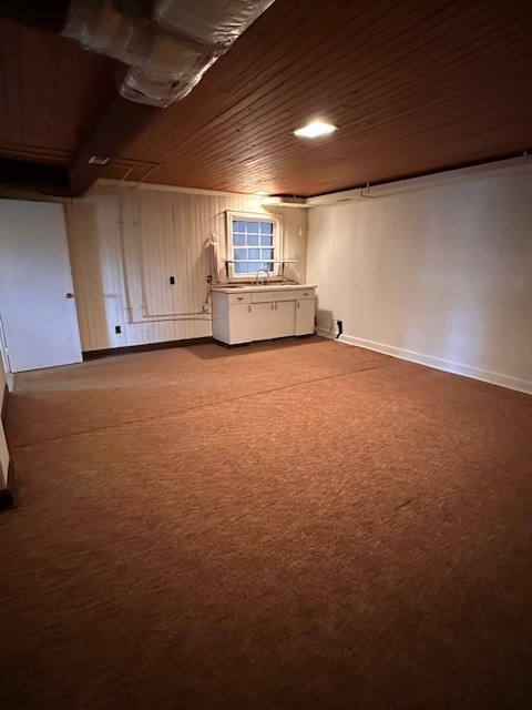 basement with carpet flooring and wood ceiling