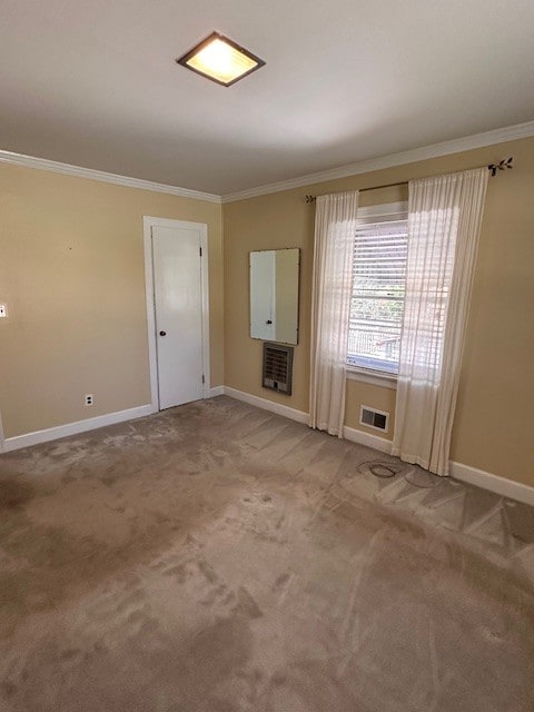 unfurnished living room featuring ornamental molding and light carpet