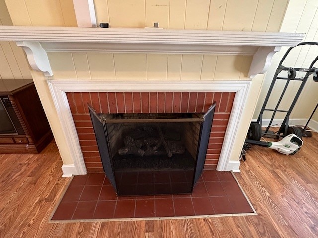 interior details with a fireplace and dark wood-type flooring