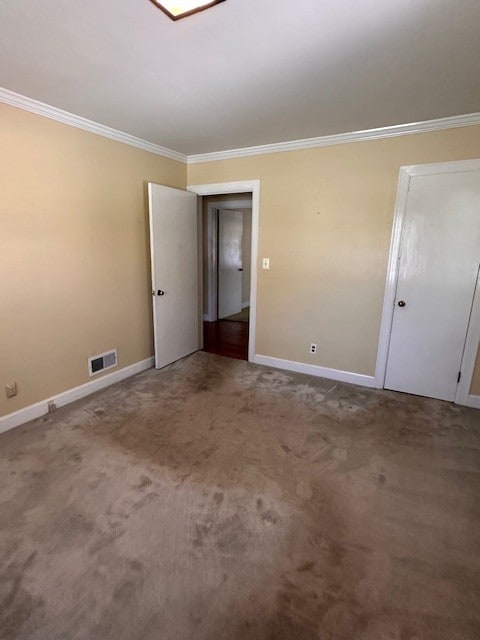 carpeted empty room with crown molding