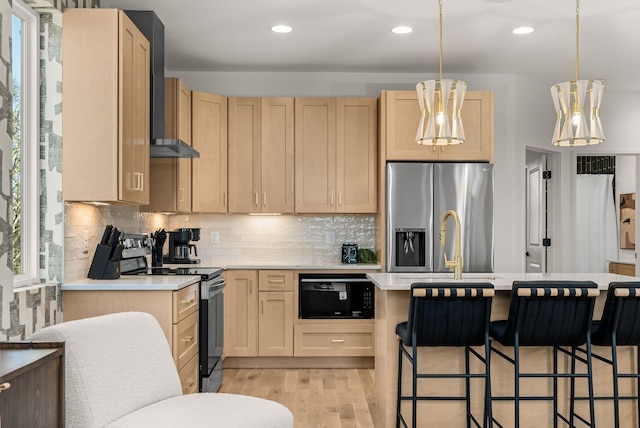 kitchen with tasteful backsplash, light brown cabinetry, and stainless steel appliances