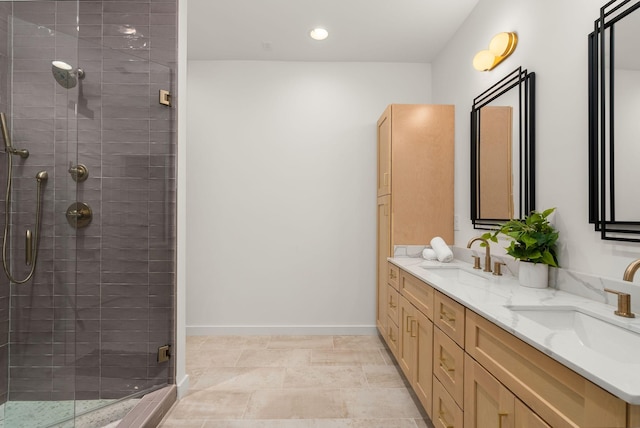 bathroom featuring a shower with shower door and vanity