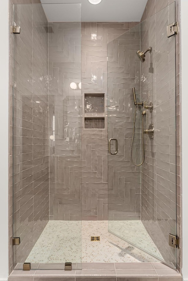 bathroom with a shower with shower door