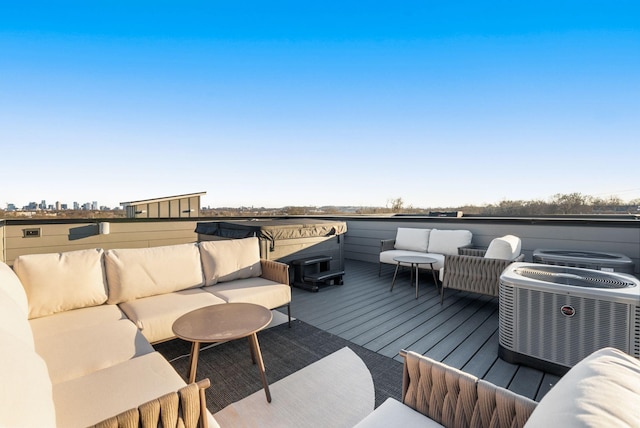 wooden terrace featuring central air condition unit and outdoor lounge area