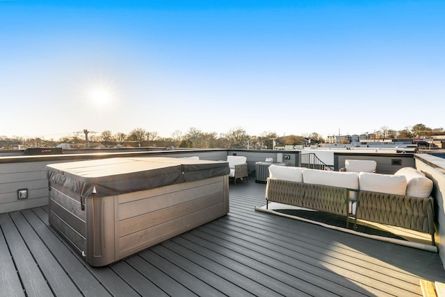 wooden terrace with a hot tub and outdoor lounge area