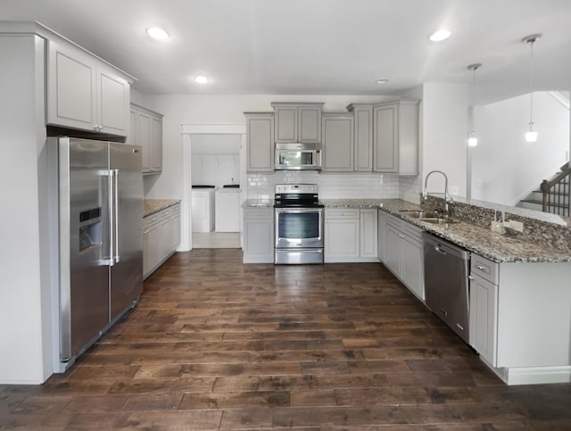 kitchen featuring pendant lighting, sink, gray cabinets, and appliances with stainless steel finishes