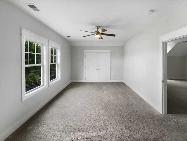 unfurnished bedroom featuring ceiling fan and carpet