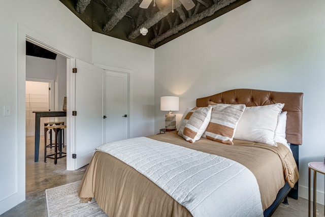 bedroom with concrete flooring and ceiling fan