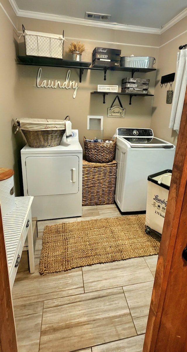 washroom with crown molding and washer / clothes dryer