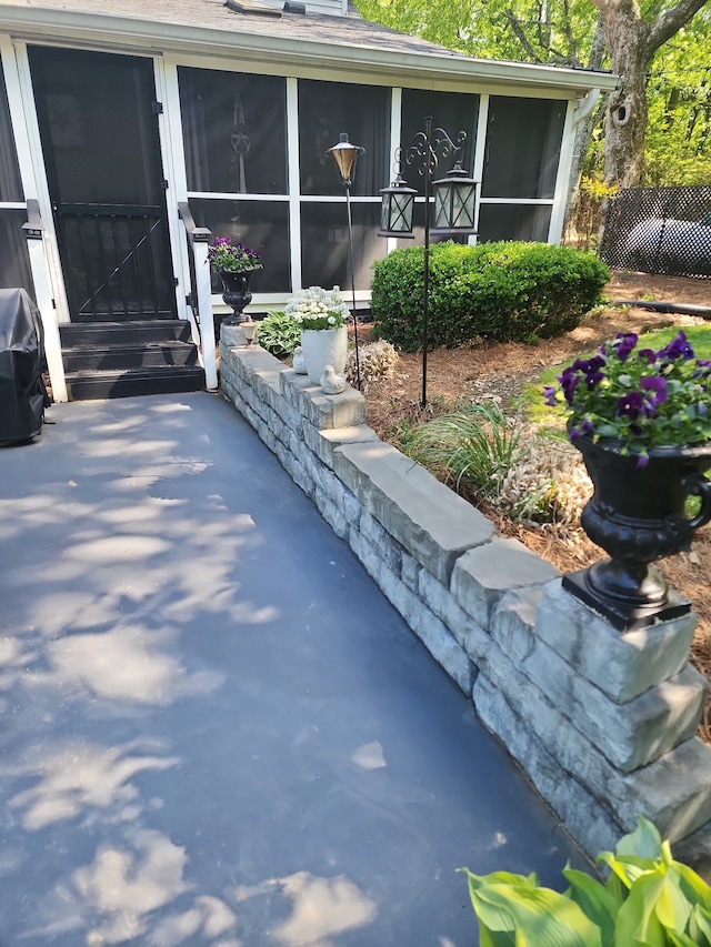 view of patio featuring a sunroom