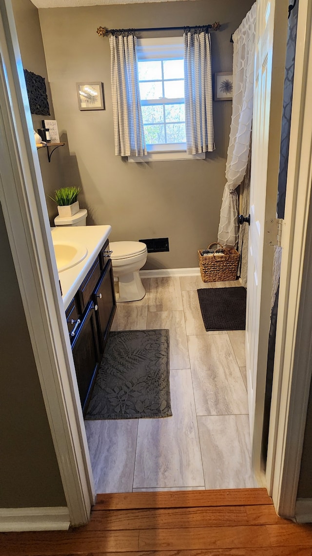 bathroom featuring vanity and toilet