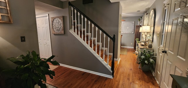 staircase with hardwood / wood-style floors