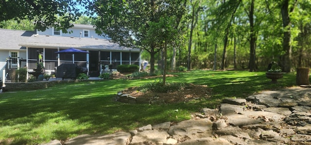 view of yard with a sunroom