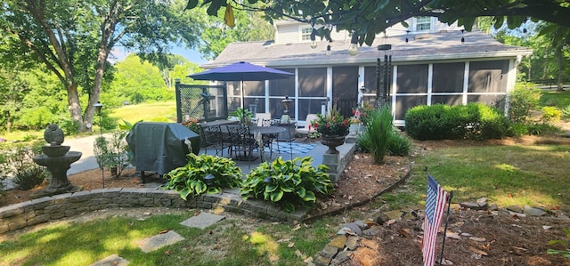 back of house featuring a patio and a sunroom