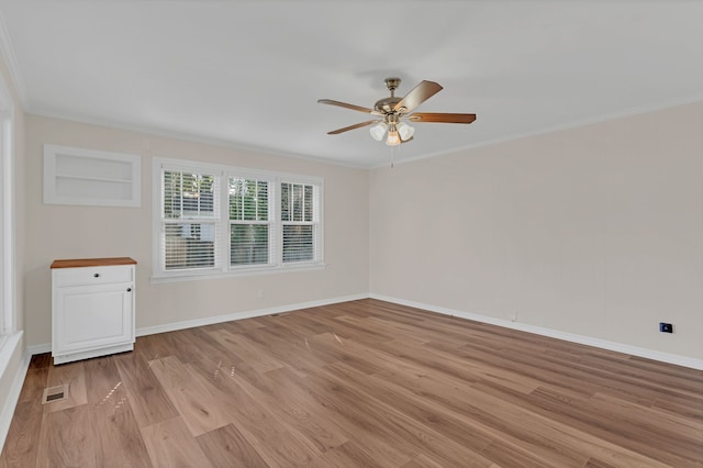 spare room featuring ceiling fan, ornamental molding, and light hardwood / wood-style flooring