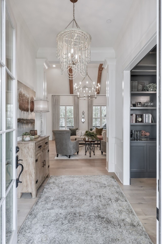 dining room featuring a notable chandelier, light wood-type flooring, and crown molding