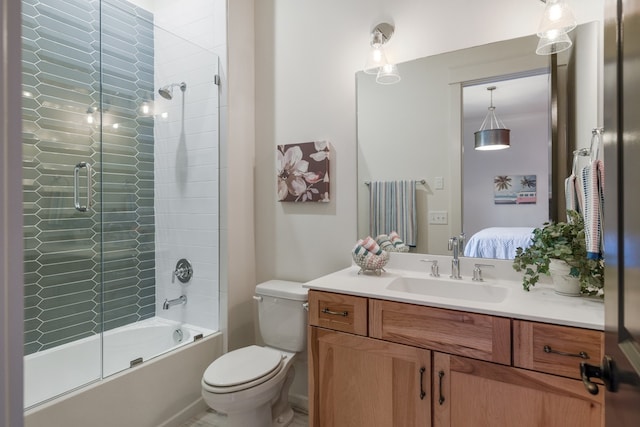 full bathroom with vanity, toilet, and bath / shower combo with glass door