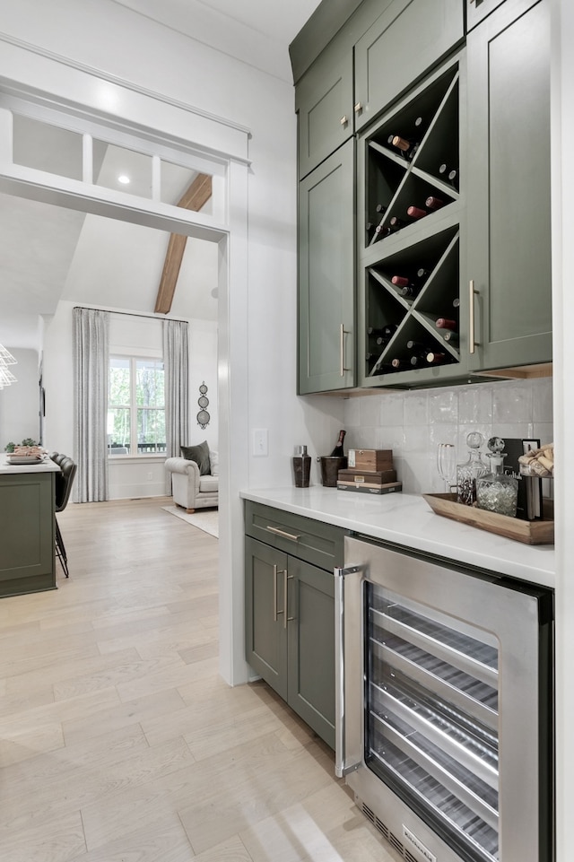 bar with vaulted ceiling with beams, backsplash, wine cooler, and green cabinetry