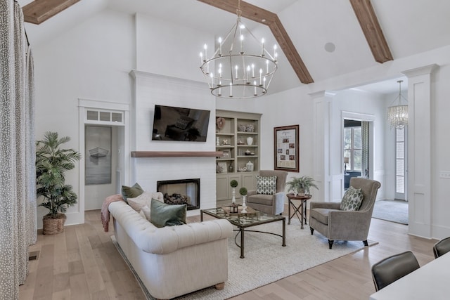 living room with ornate columns, beam ceiling, high vaulted ceiling, a fireplace, and light hardwood / wood-style floors