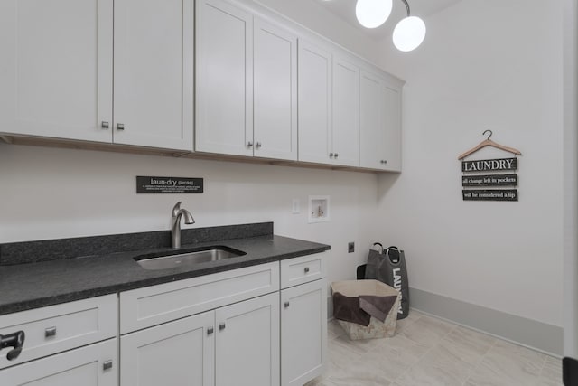 laundry area with washer hookup, electric dryer hookup, cabinets, and sink