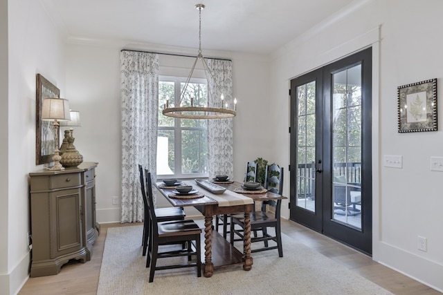 dining area featuring plenty of natural light, crown molding, and french doors