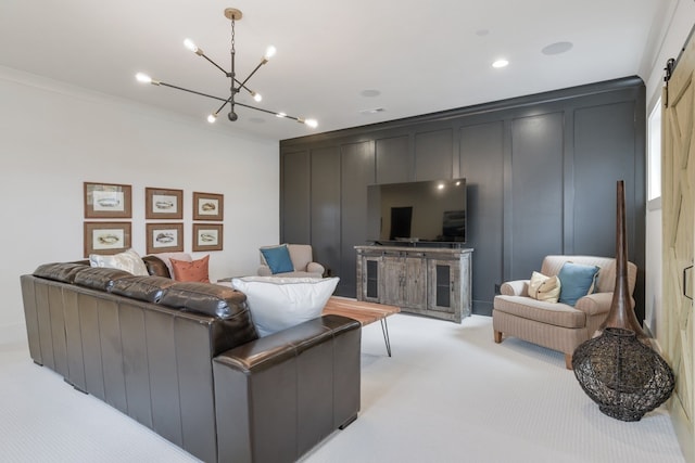 carpeted living room featuring a barn door, an inviting chandelier, and ornamental molding