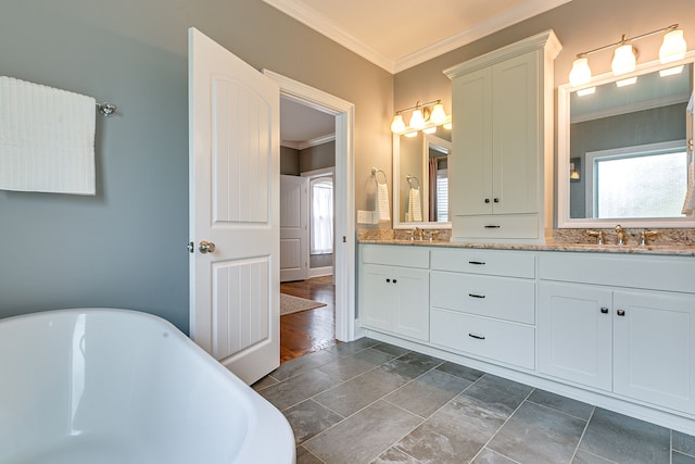 bathroom featuring a tub, large vanity, dual sinks, hardwood / wood-style flooring, and crown molding