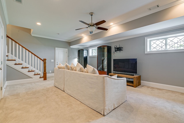 carpeted living room with crown molding and ceiling fan