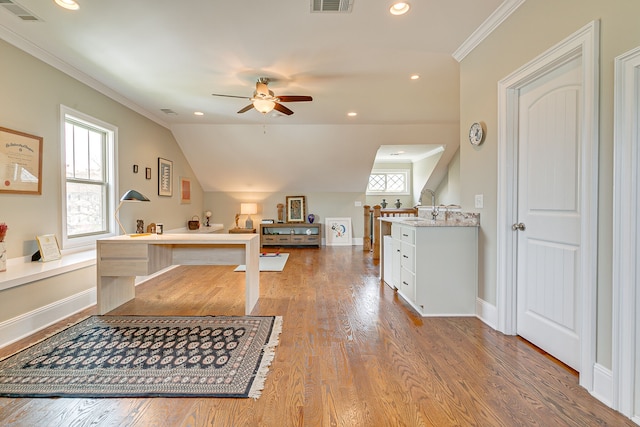 bedroom with lofted ceiling, light hardwood / wood-style floors, and crown molding