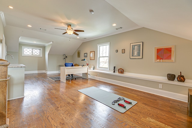 workout area featuring dark hardwood / wood-style flooring, ceiling fan, lofted ceiling, and plenty of natural light