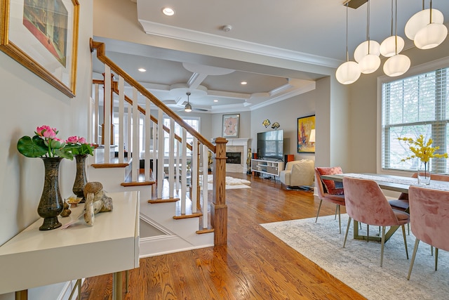 foyer entrance featuring coffered ceiling, ceiling fan, beamed ceiling, hardwood / wood-style flooring, and ornamental molding