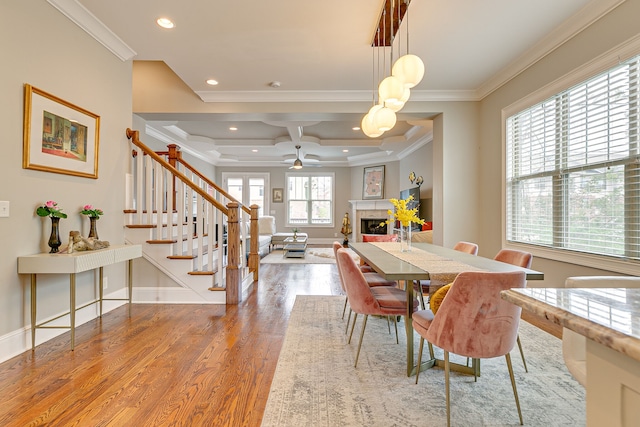 dining room featuring beamed ceiling, ceiling fan, coffered ceiling, light hardwood / wood-style floors, and crown molding