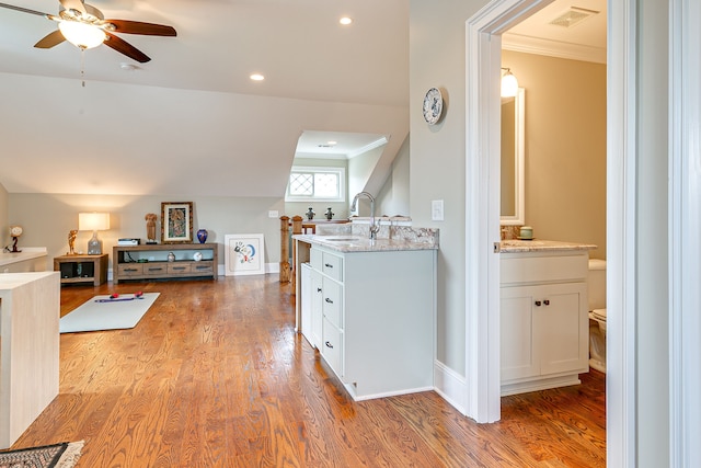 hallway with ornamental molding, dark hardwood / wood-style floors, and sink