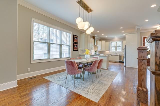 dining room featuring ornamental molding and dark hardwood / wood-style floors