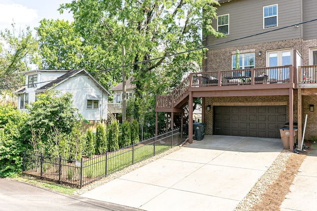 view of front of property featuring a wooden deck and a garage