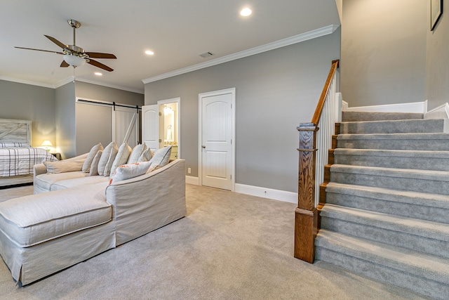 interior space with ceiling fan, crown molding, and a barn door