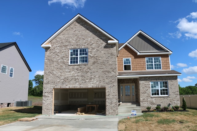 craftsman-style house with cooling unit and a garage