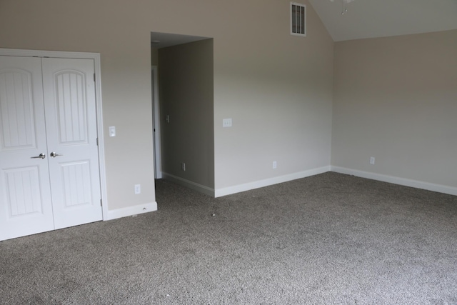 unfurnished bedroom with a closet and dark colored carpet