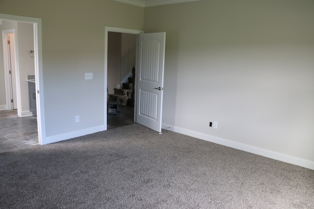 unfurnished bedroom featuring carpet and ornamental molding