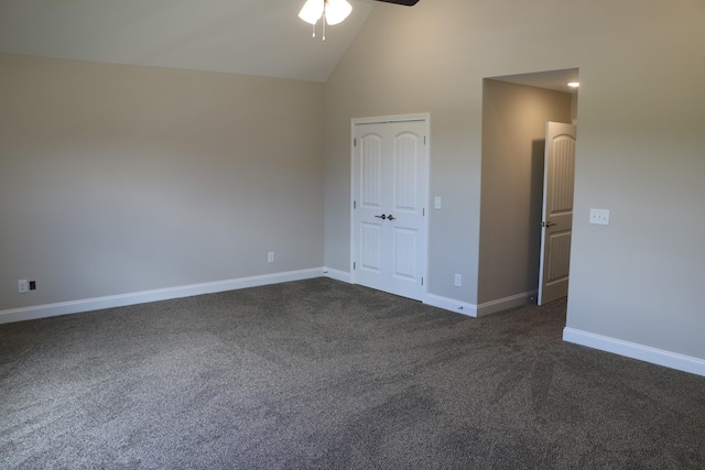 unfurnished bedroom with ceiling fan, high vaulted ceiling, and dark carpet